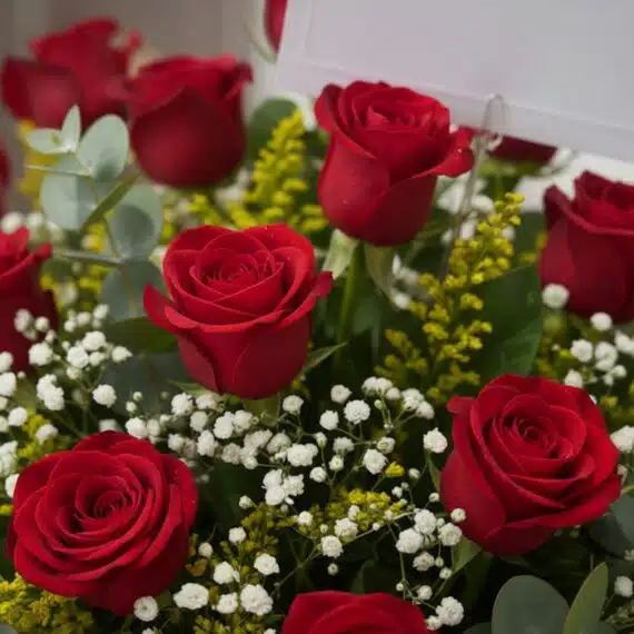 Primer plano extremo de un Arreglo Floral Escarlata con rosas rojas frescas, gotas de rocío sutiles, follaje verde y flores b